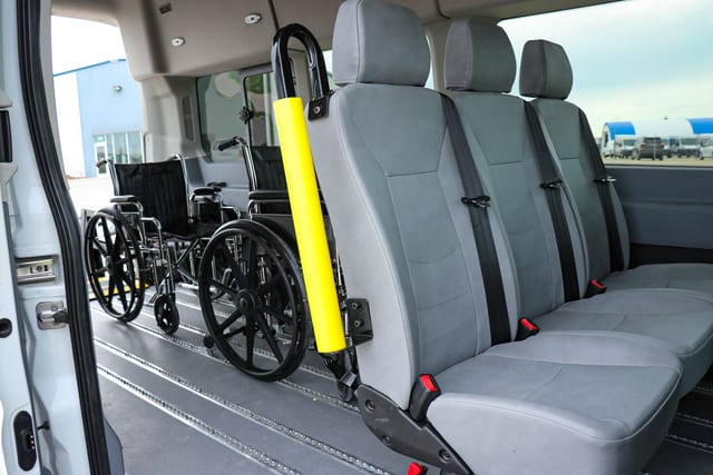 three removeable seats and two wheelchairs secured in a Ford Transit wheelchair van converted at MoveMobility