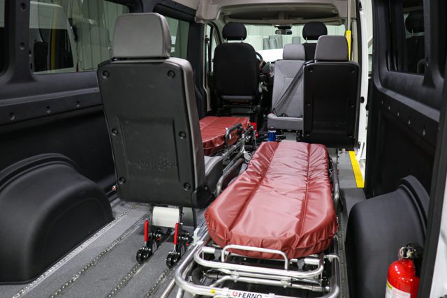 attendant seat beside a stretcher inside a non emergency medical van