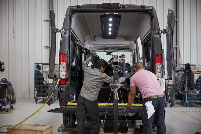 Men building a wheelchair van