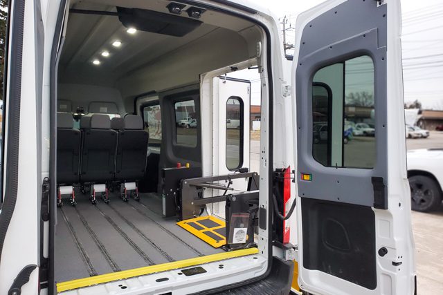 2022 Ford Transit with rear doors open, showing MoveMobility T6 paratransit conversion with rear lift