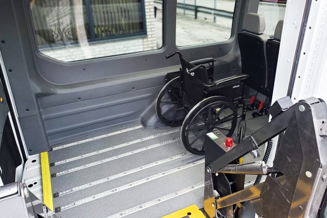 Wheelchair and seat space with AutoFloor inside paratransit van