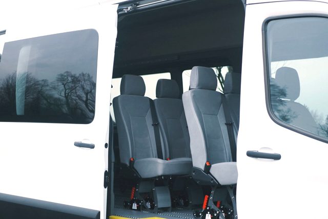 Ford Transit sliding door open, showing removeable paratransit seats