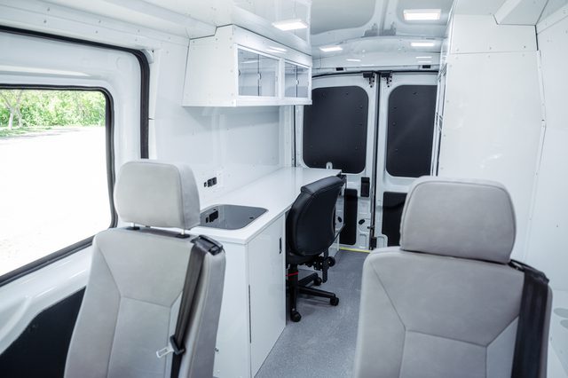 Inside Mobile Outreach van (MO Model) showing two seats for possible patient transfer/treatment.
