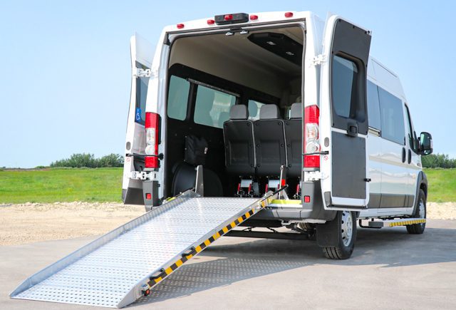 Rear view of rear entry Ram Promaster wheelchair van with manual ramp.