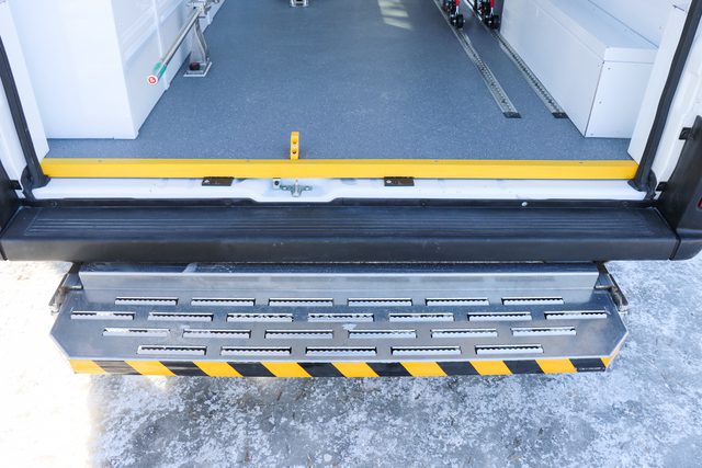 Fold up rear step for stretcher loading