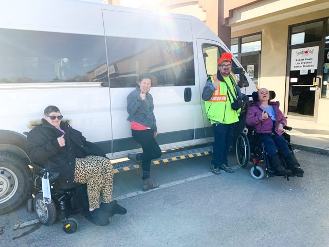 Connect ABILITY clients smiling in front of MoveMobility wheelchair van