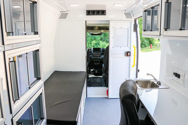 Inside Mobile Clinic Van with office space and exam bed